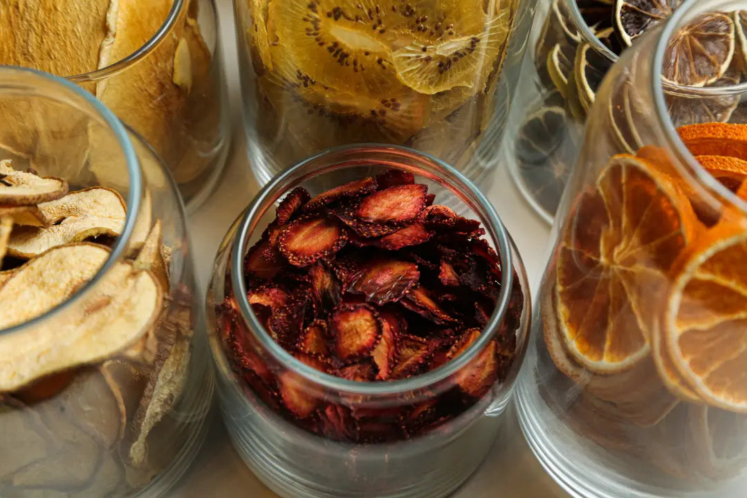 Assorted dried citrus wheels arranged as cocktail garnishes on a marble surface